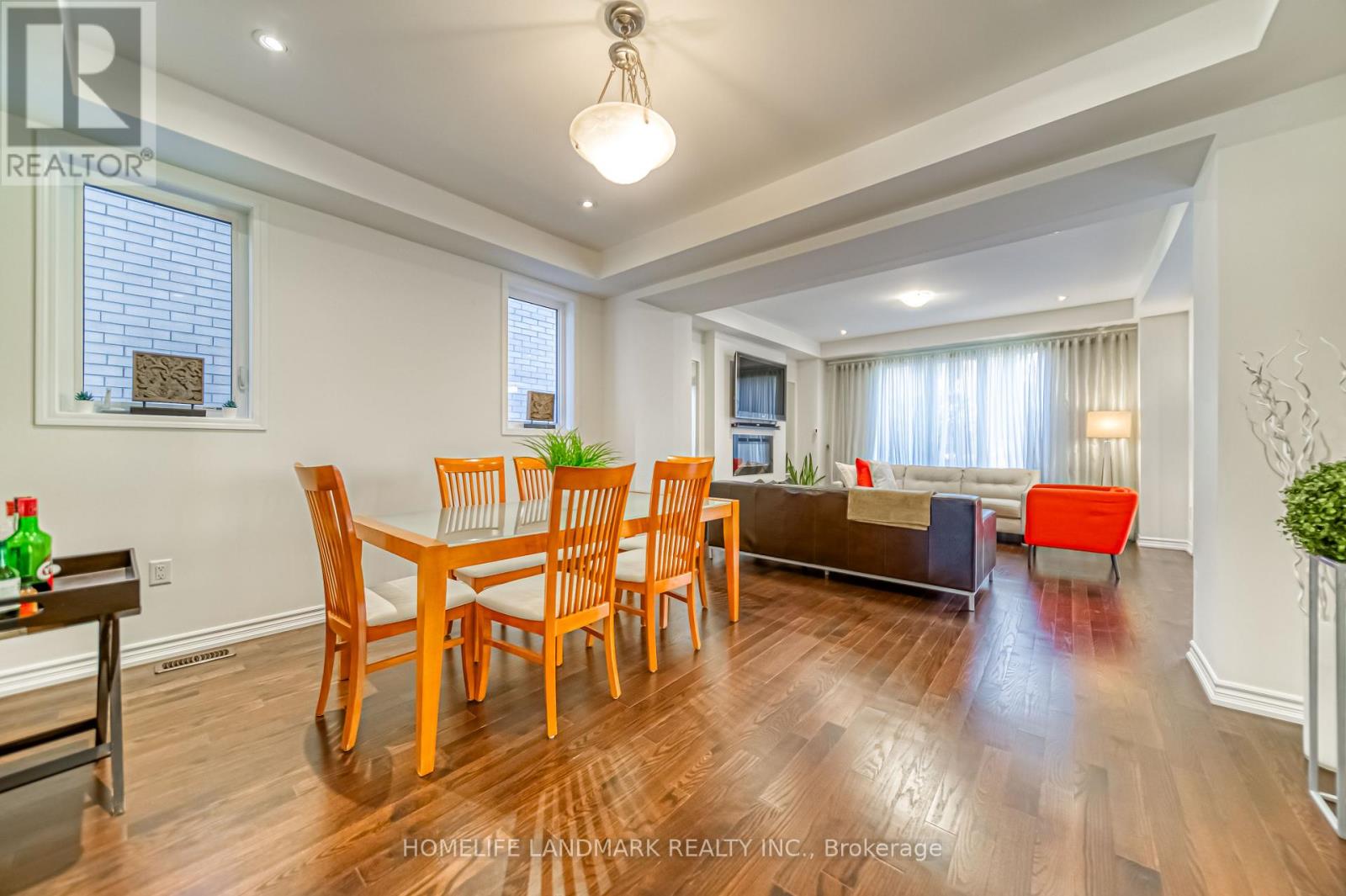 A dining room with a wooden table and chairs.