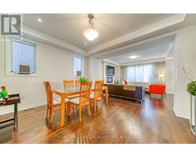 A dining room with a wooden table and chairs.