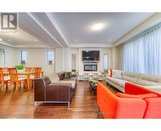 A living room with a white couch and a brown leather chair.