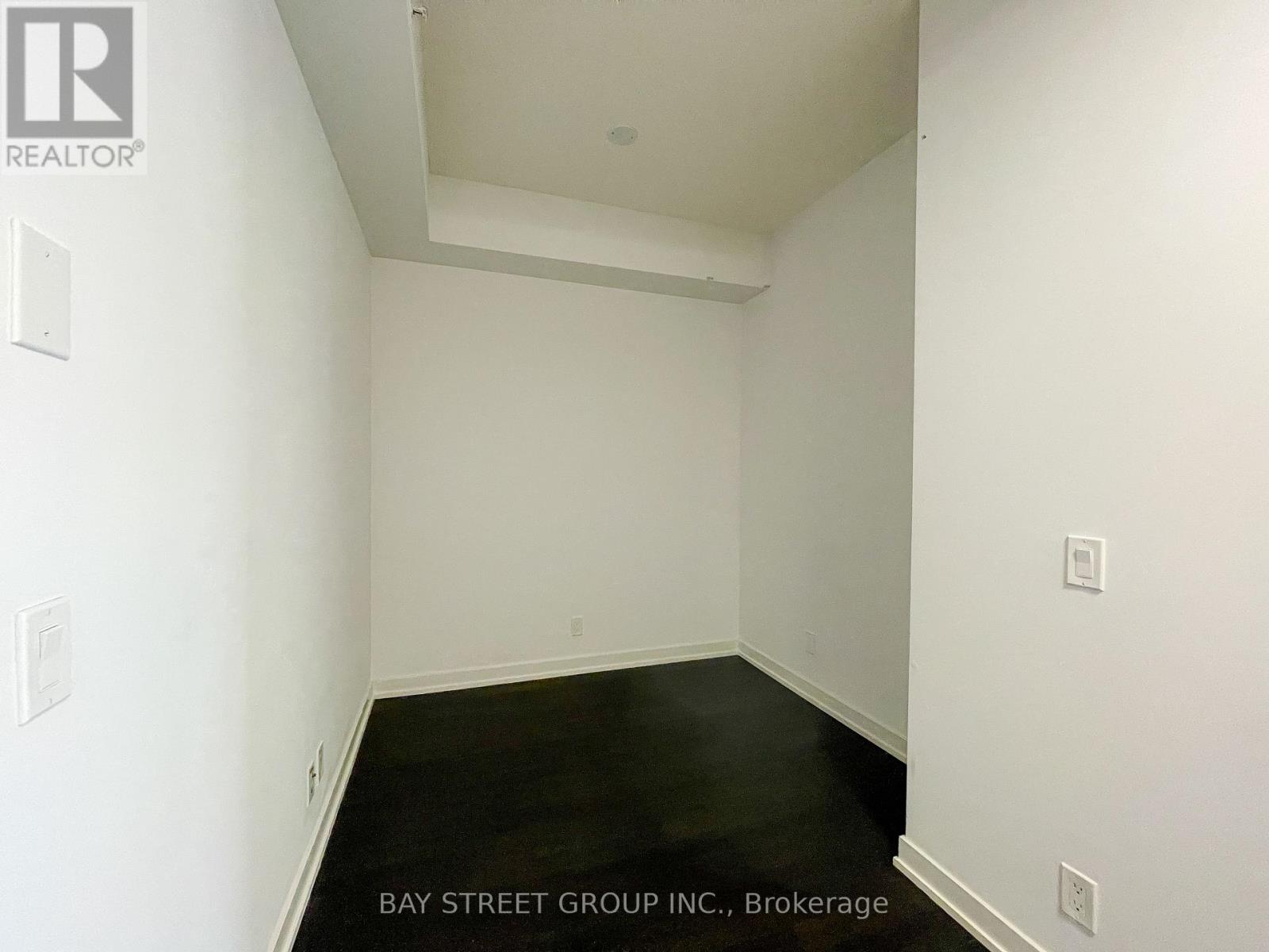 A room with white walls and a black floor.