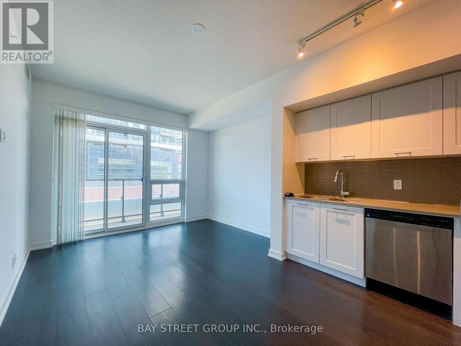 A spacious kitchen with white cabinets and a dishwasher.