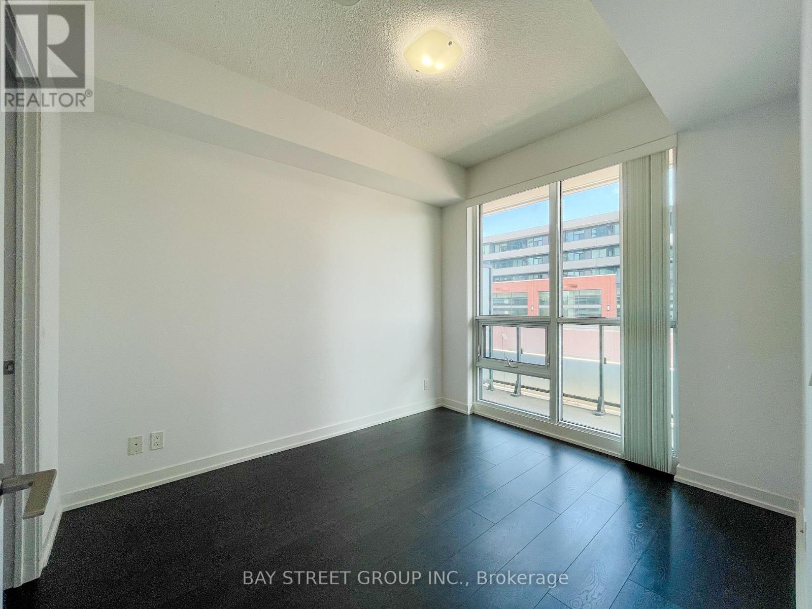 A spacious room with a view of the city through the windows.