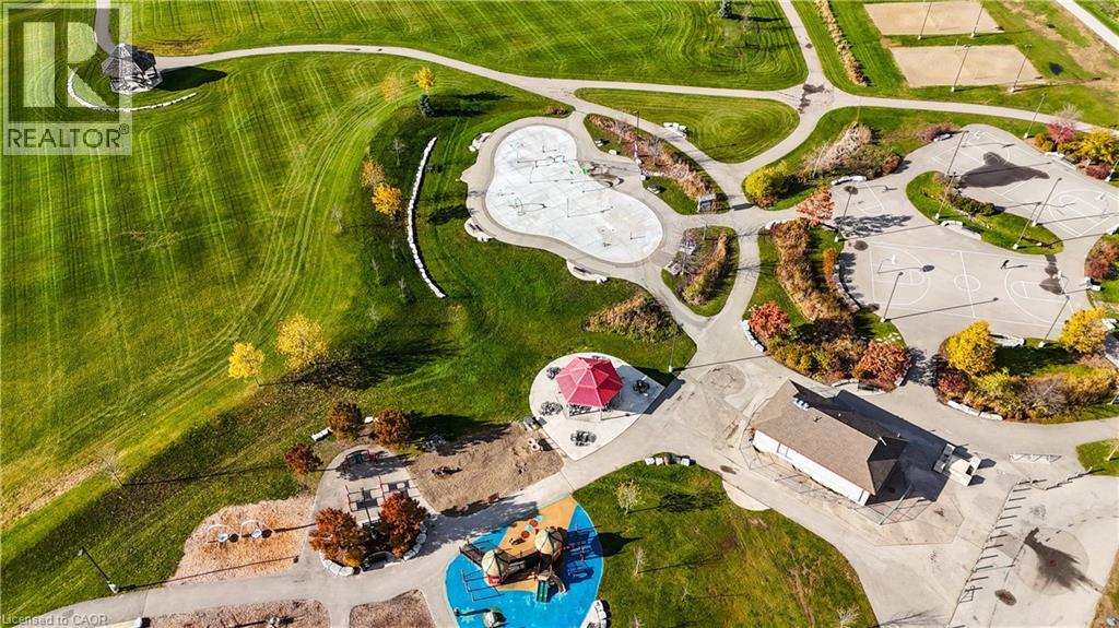 A bird's eye view of a residential area with a swimming pool and a playground.