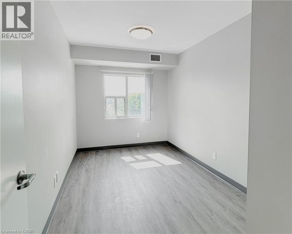 A spacious room with a window and a door.