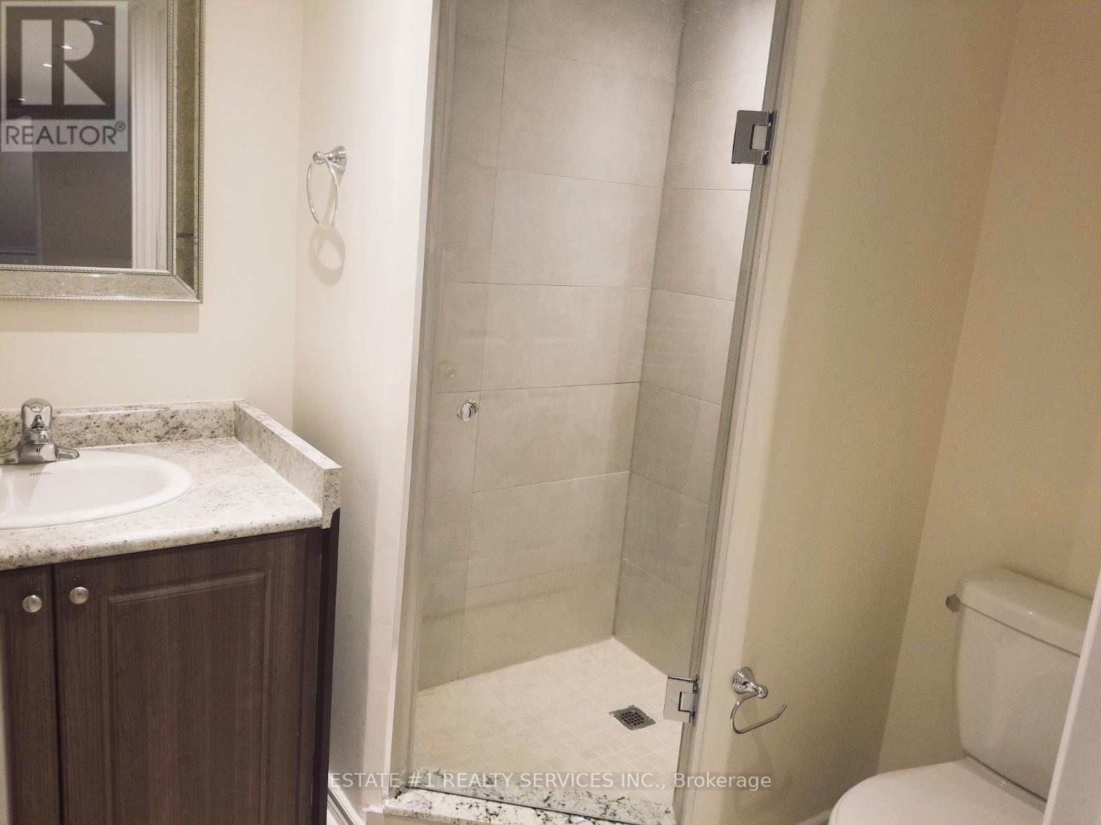 A bathroom with a sink, toilet and shower.