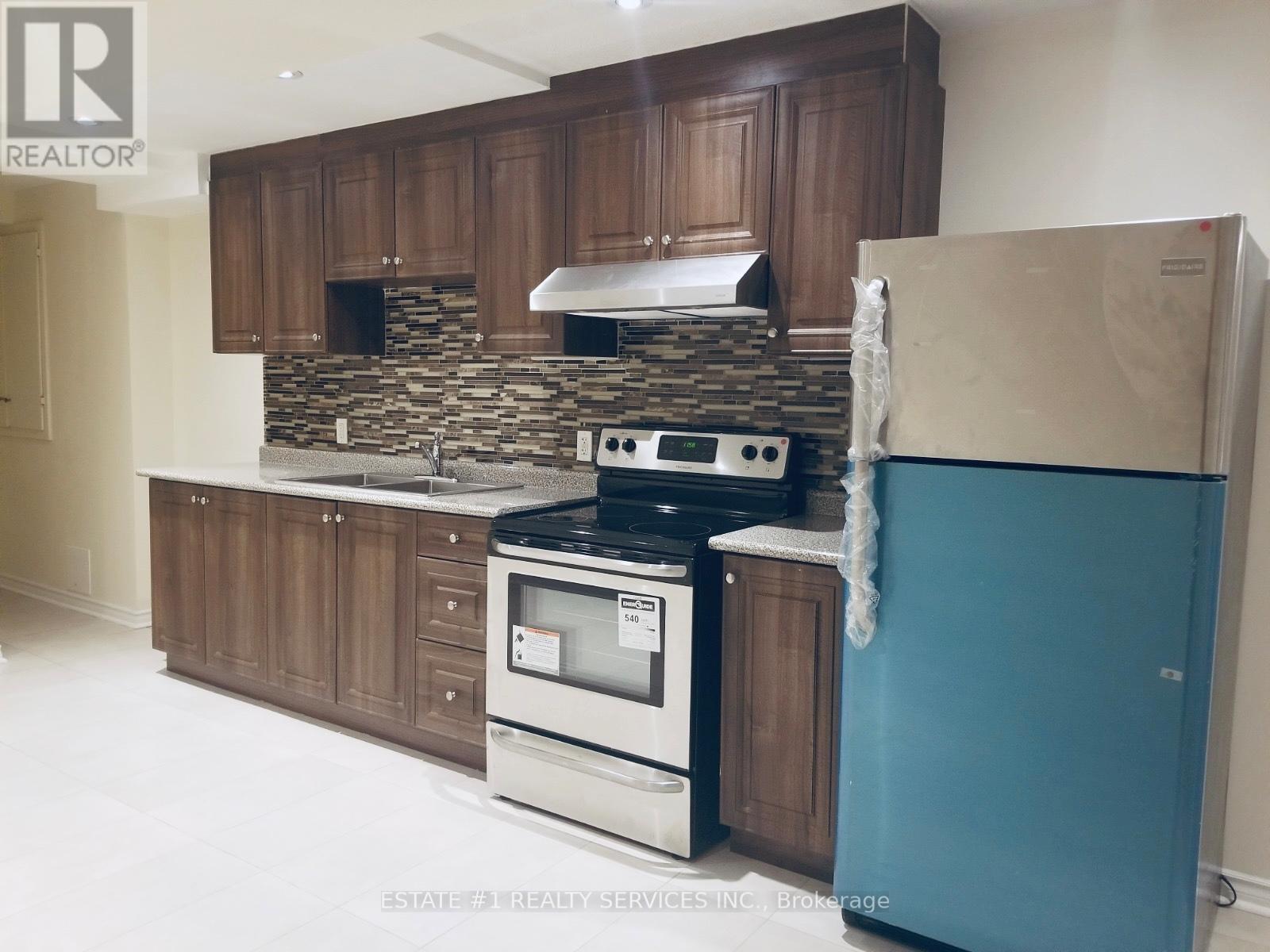 A kitchen with a stove, oven, and refrigerator.
