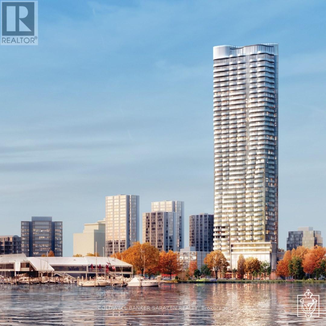A tall building stands in front of a row of smaller buildings.