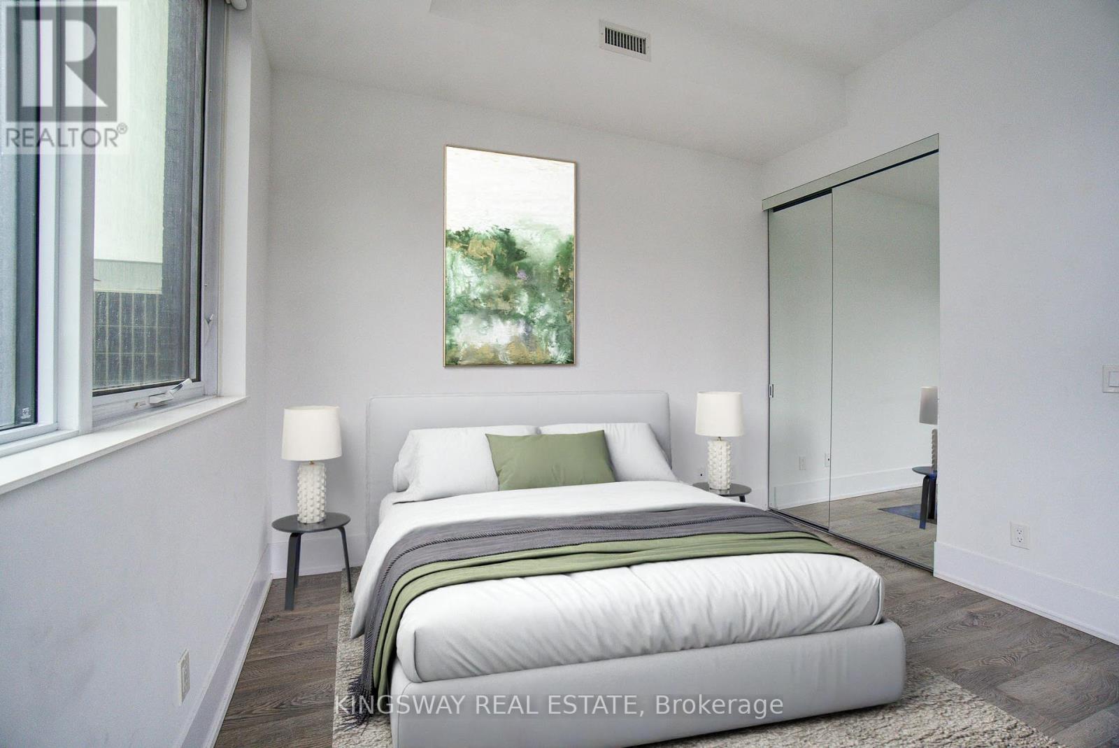 A bedroom with a large bed and a window.