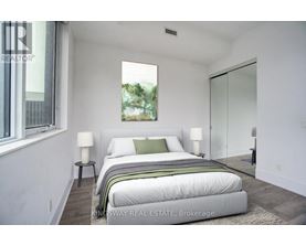 A bedroom with a large bed and a window.