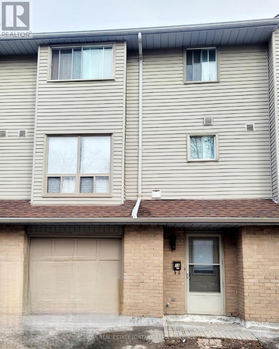 A two story house with a garage door.