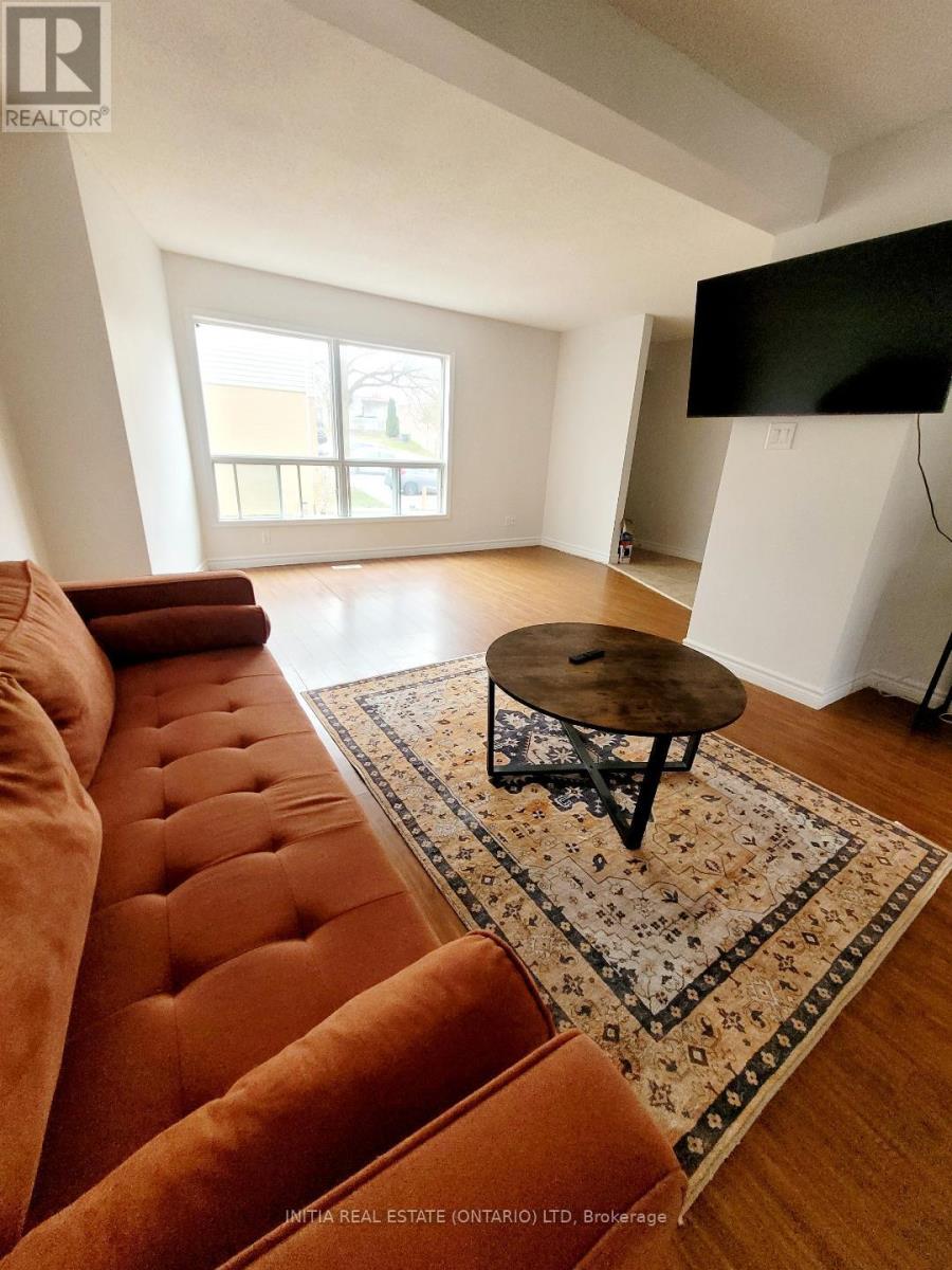 A kitchen with white cabinets and appliances is for sale.