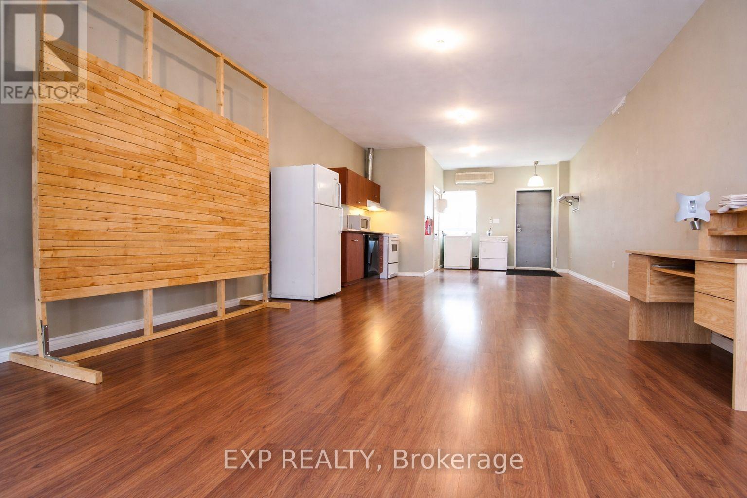 A room with wooden floors and a wooden partition wall.