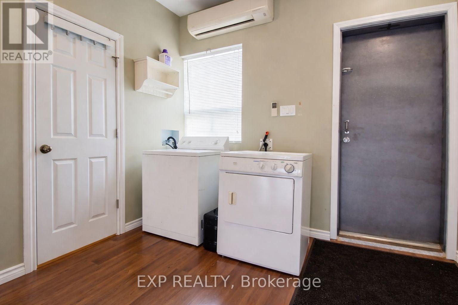 A white oven and dishwasher in a kitchen with a door to the right.