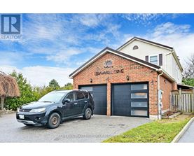 A house with a garage and a car parked in front.
