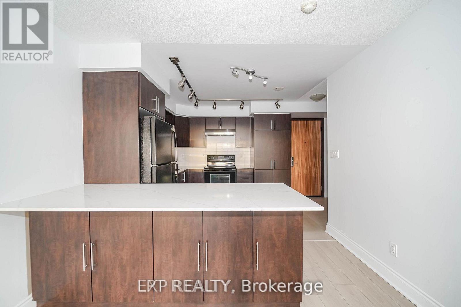 A kitchen with wooden cabinets and a white countertop.
