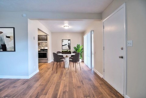 A dining room with a table and chairs.