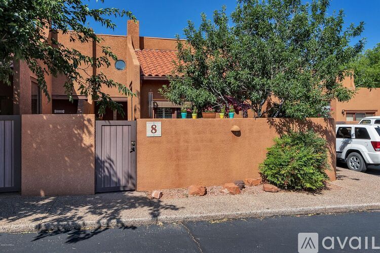 A house numbered 8 with a tree in front.