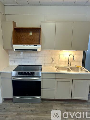 A kitchen with a black dishwasher and a black oven.