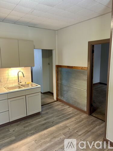 A kitchen with white cabinets and a sink.