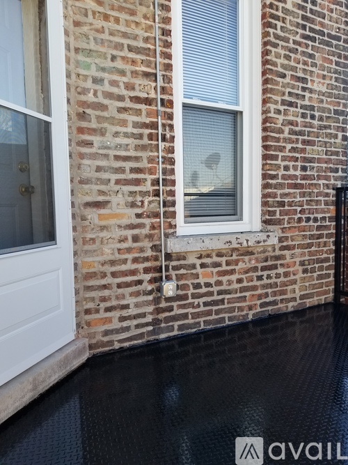 A brick building with a white door and window.