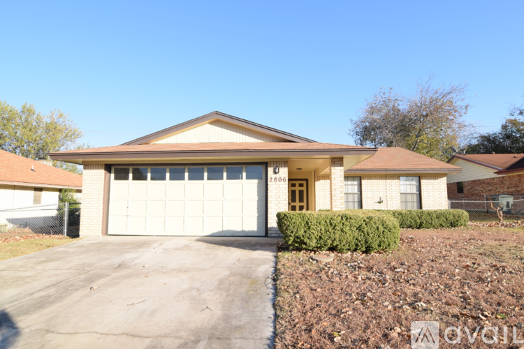 A two-story house with a garage is for sale.