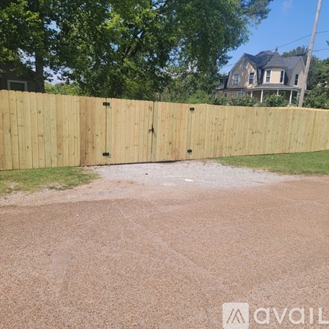 A wooden fence in front of a house.