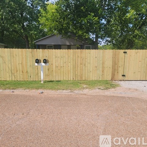 A wooden fence with a mailbox on it.