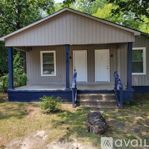 A small house with a porch and a door.