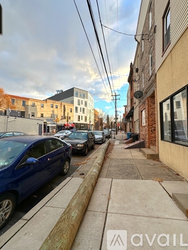 A blue car is parked on the side of a street.