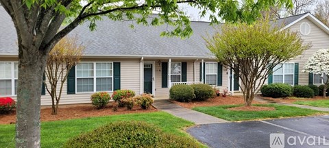 A house with a tree in front of it.