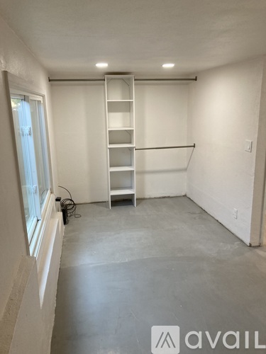 A room with a ladder and a window.