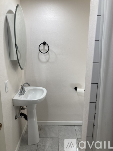 A white sink in a small bathroom.
