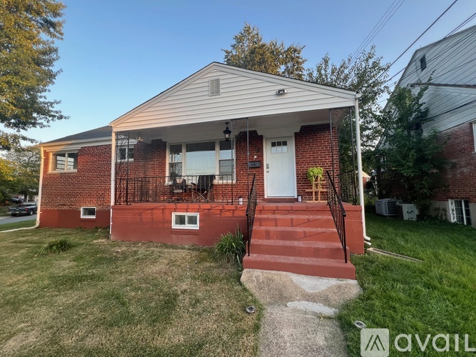 A house with a red brick exterior and a white door is for sale.