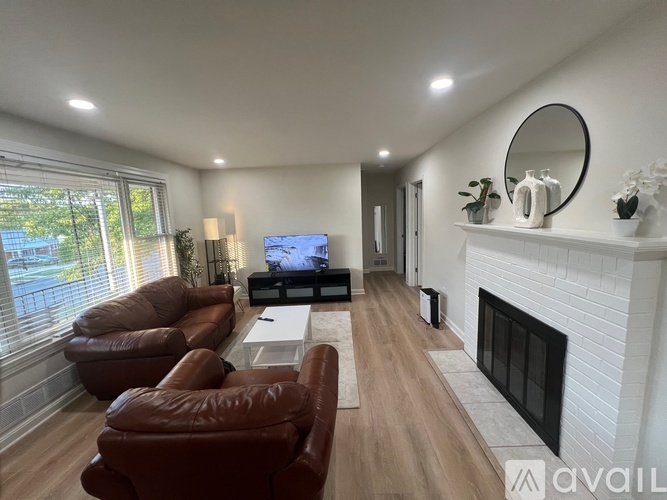 A living room with a fireplace and a television.