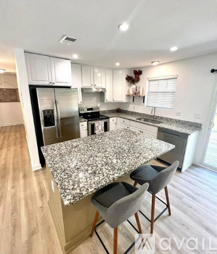 A kitchen with granite countertops and stainless steel appliances.