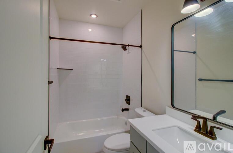 A bathroom with a toilet, sink, and shower.