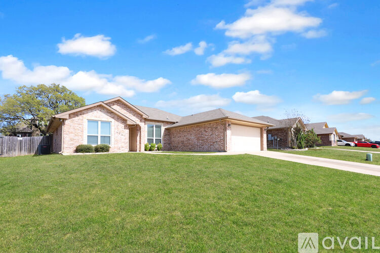 A house with a garage and a driveway is available for sale.