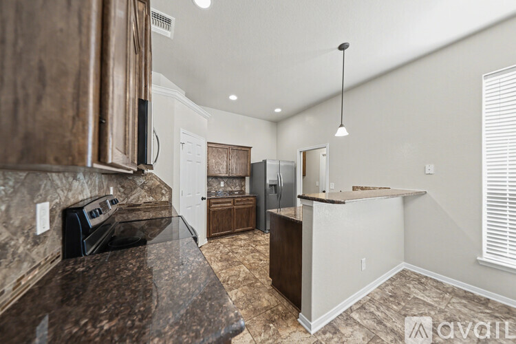 A spacious room with a ceiling fan and tiled flooring.