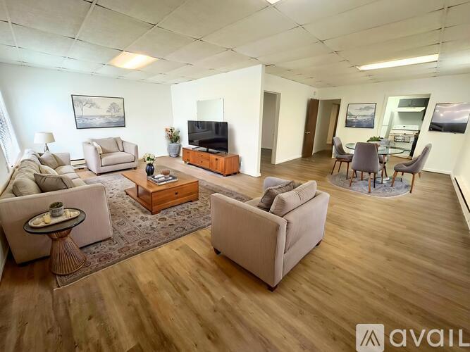 A living room with a television, couches, and a coffee table.