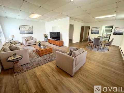 A living room with a television, couches, and a coffee table.