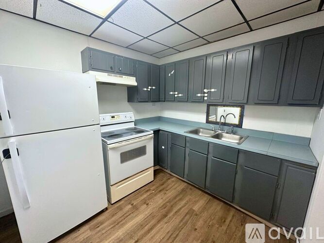A kitchen with a white refrigerator and a white oven.