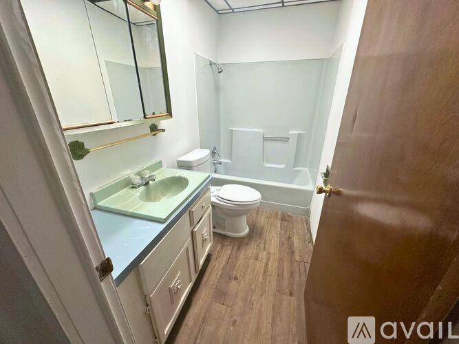 A bathroom with a toilet, sink, and bathtub.