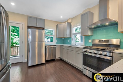 A kitchen with a stainless steel refrigerator and oven.