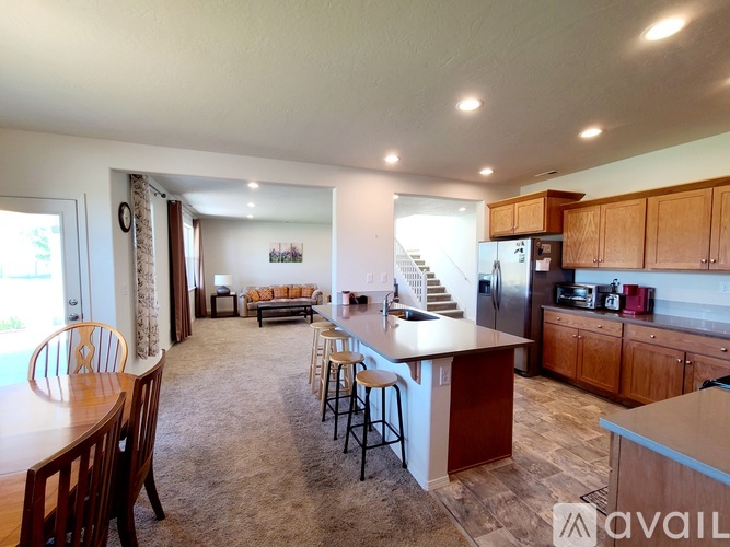A kitchen with a bar and a dining table.