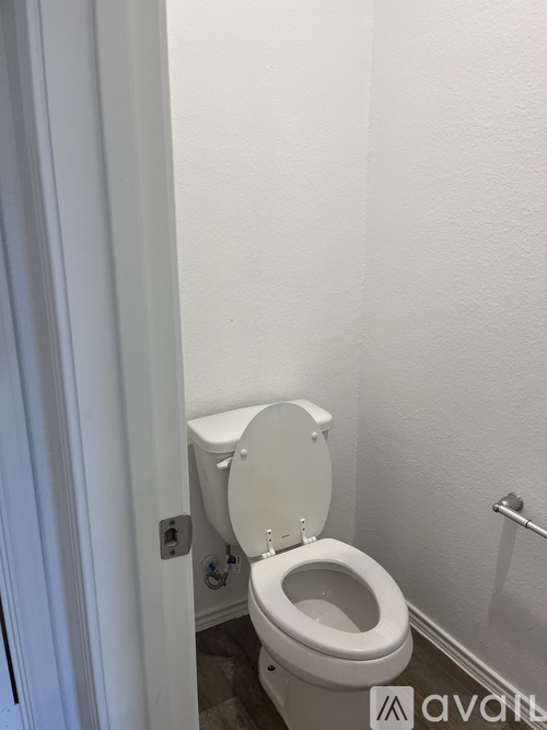 A white toilet in a small bathroom.
