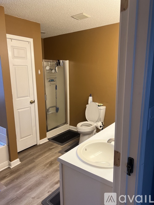 A bathroom with brown walls and a white toilet.