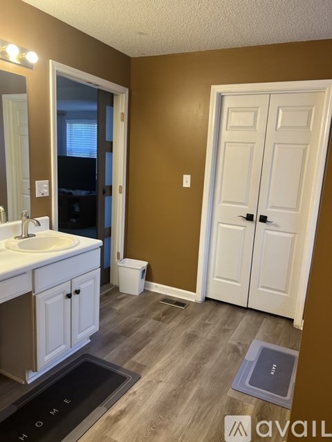 A bathroom with brown walls and a white door.