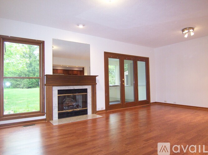 A room with a fireplace and wooden floors.