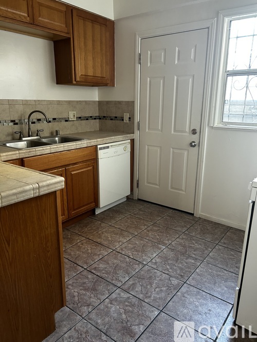 A kitchen with a white door and a white washing machine.
