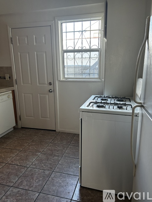 A small kitchen with a window and a gas stove.